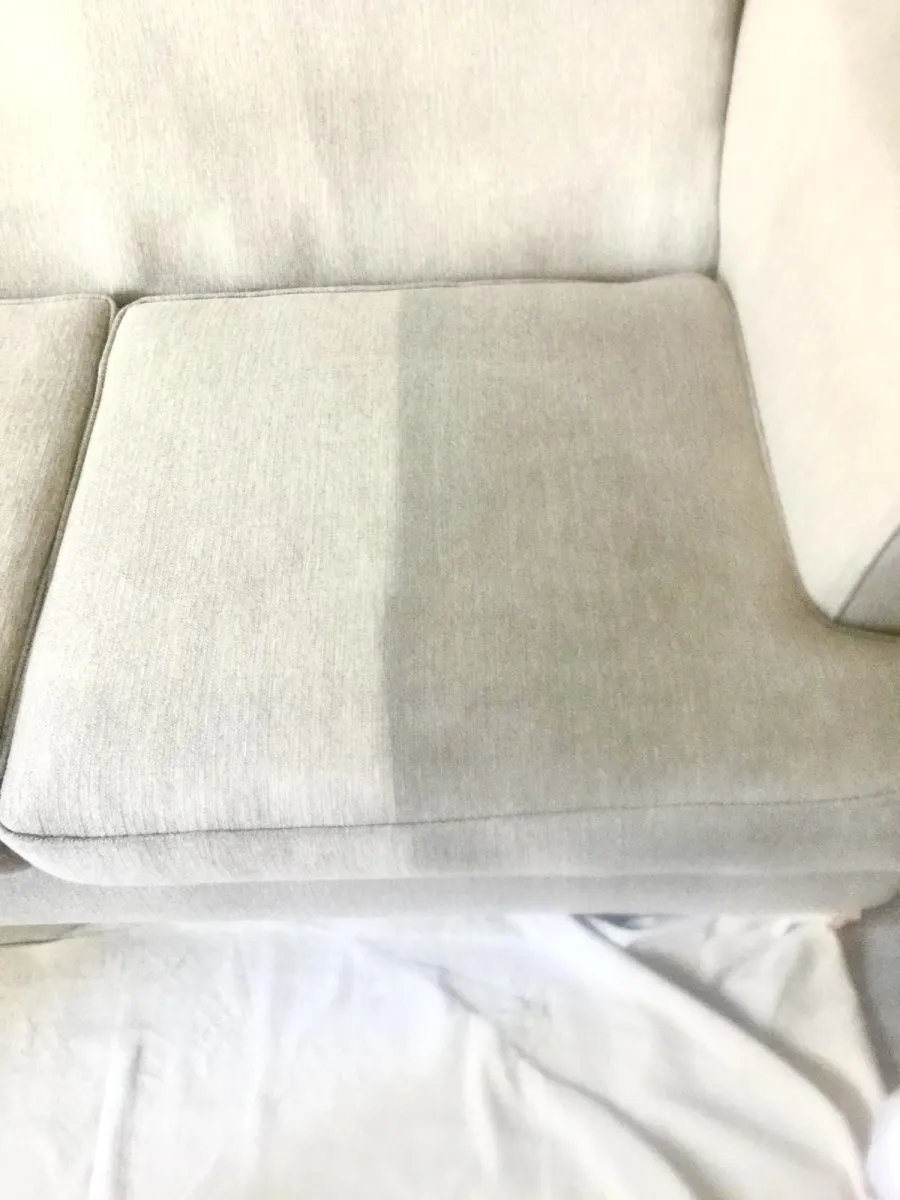 Ivory sofa cushion half cleaned to show the difference