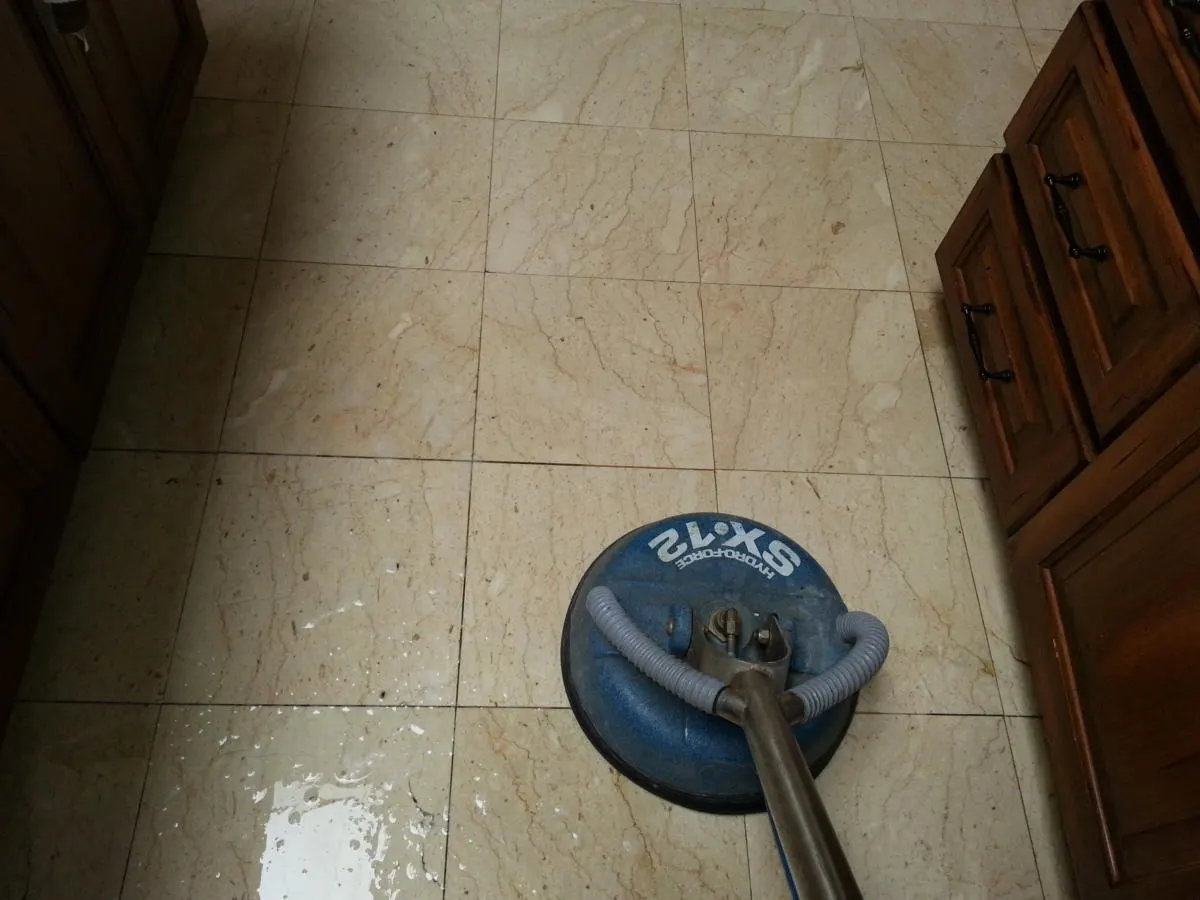 Tile floor being cleaned with a spinner tool